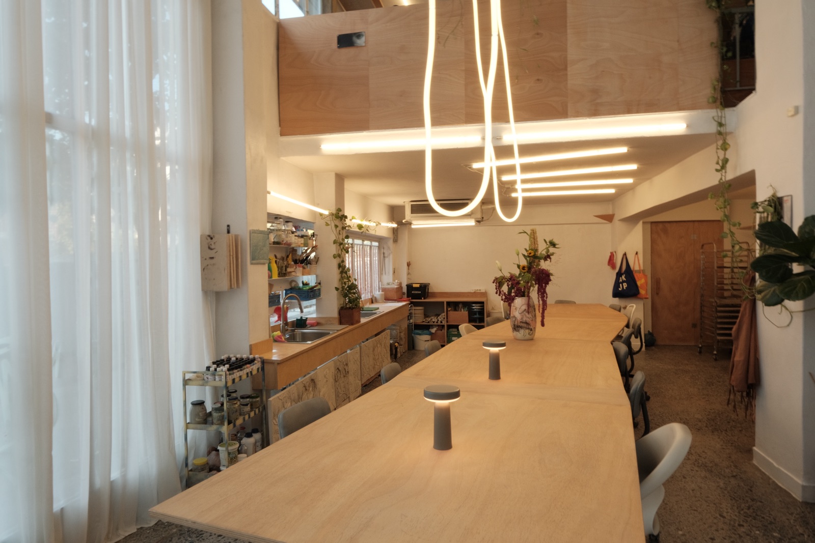 The long shared table under the lights