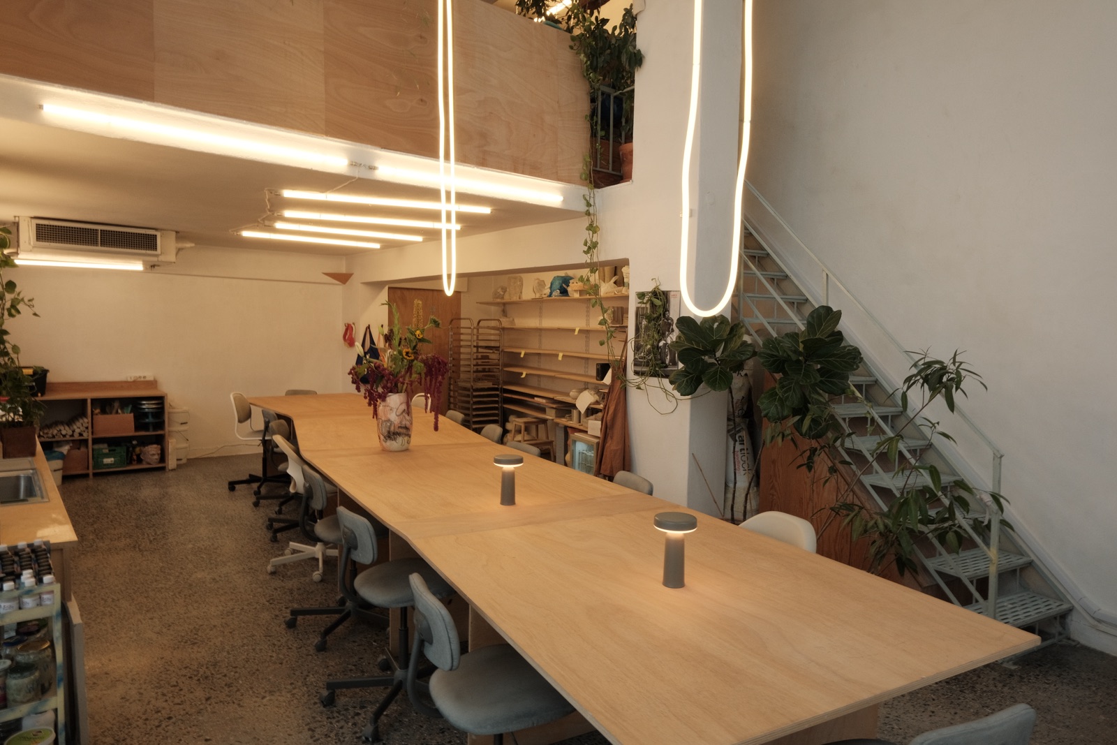 The studio with the hanging lights and the stairs